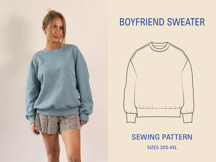 Woman wearing a blue boyfriend sweater with a sewing pattern illustration on a beige background
