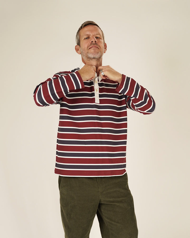 Model wearing Rugby Polo Shirt sewing pattern, striped jersey with three-button placket, relaxed fit.