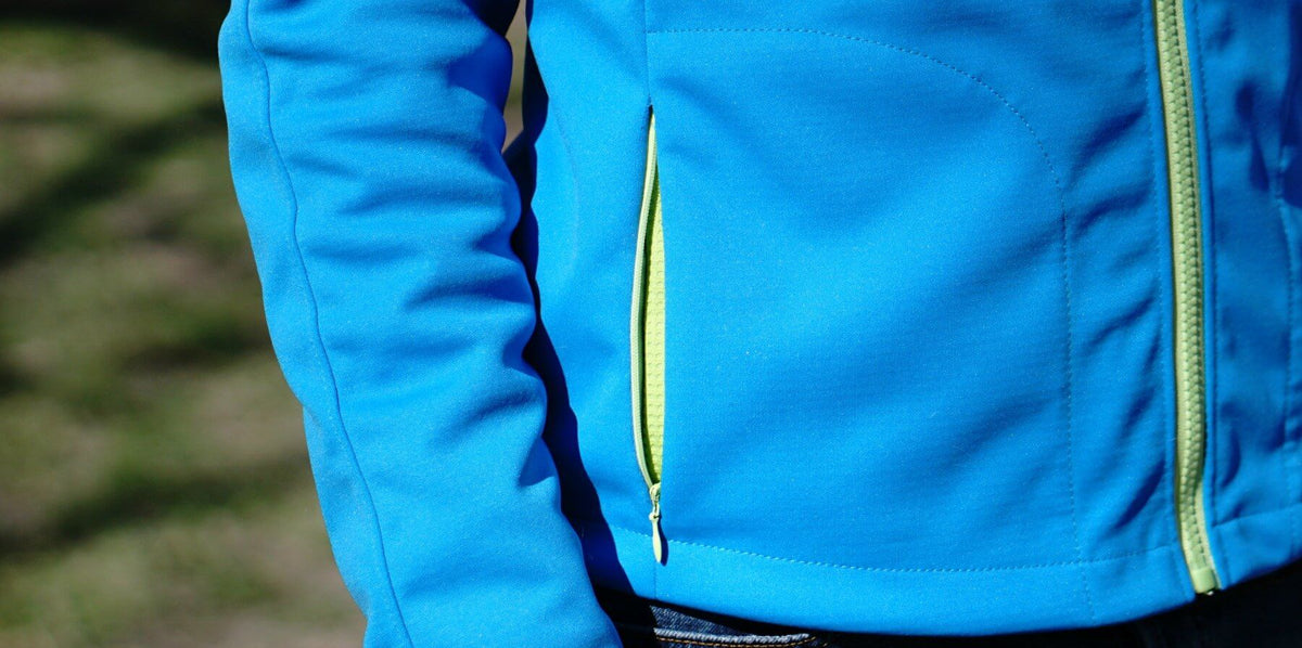 A close-up of a blue jacket featuring an invisible zipper pocket, illustrating the invisible zipper pockets tutorial.