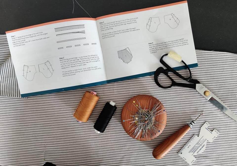 how to start sewing with sewing tools, fabric, guidebook, and scissors for beginners.