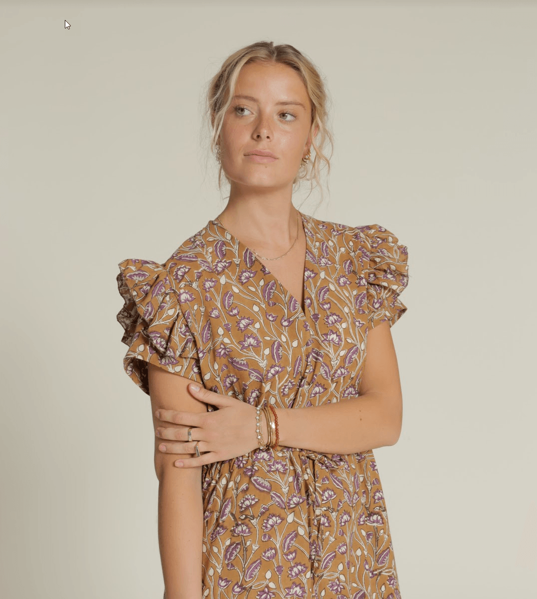 5 Reasons to Love Our New Dress Sewing Pattern - model showcasing a floral dress with ruffled sleeves.