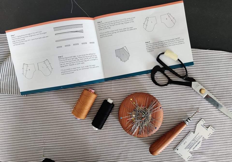 how to start sewing with sewing tools, fabric, guidebook, and scissors for beginners.