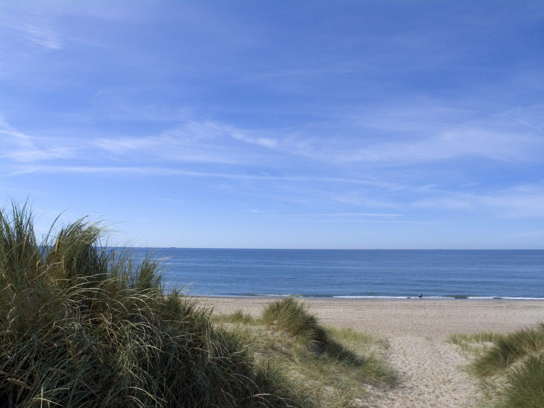 Beautiful beach view with gentle waves, perfect for stylish bikinis for beach vacation