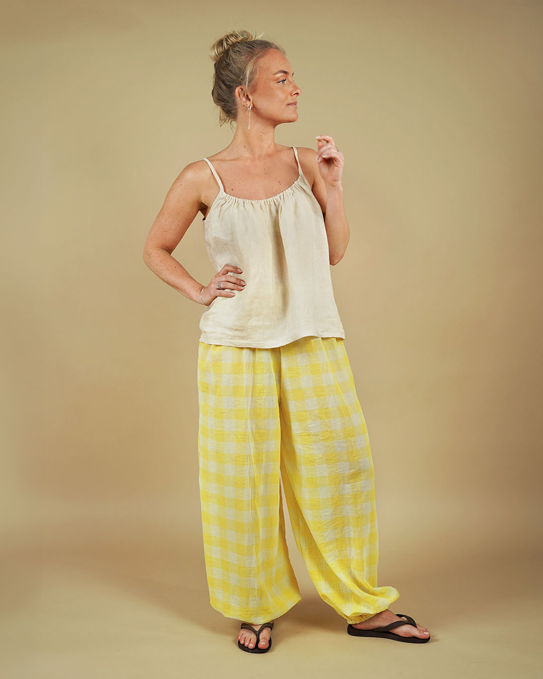 Model wearing the Bubble Pants sewing pattern in yellow checkered fabric, showcasing a floaty silhouette.