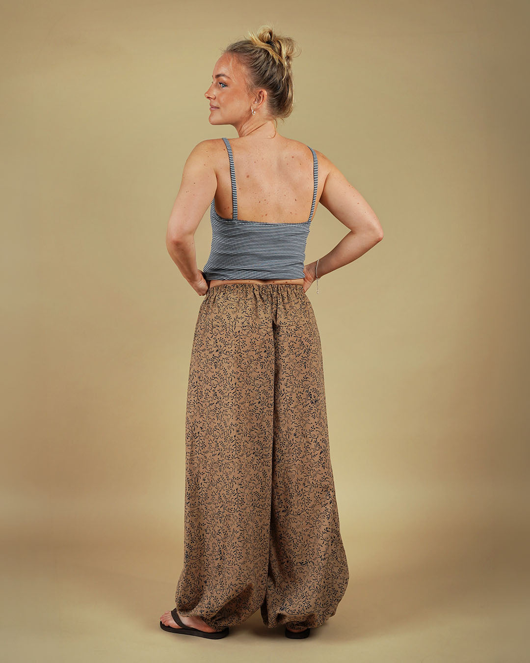 Model wearing Bubble Pants sewing pattern with voluminous legs from the back view, showcasing playful silhouette.