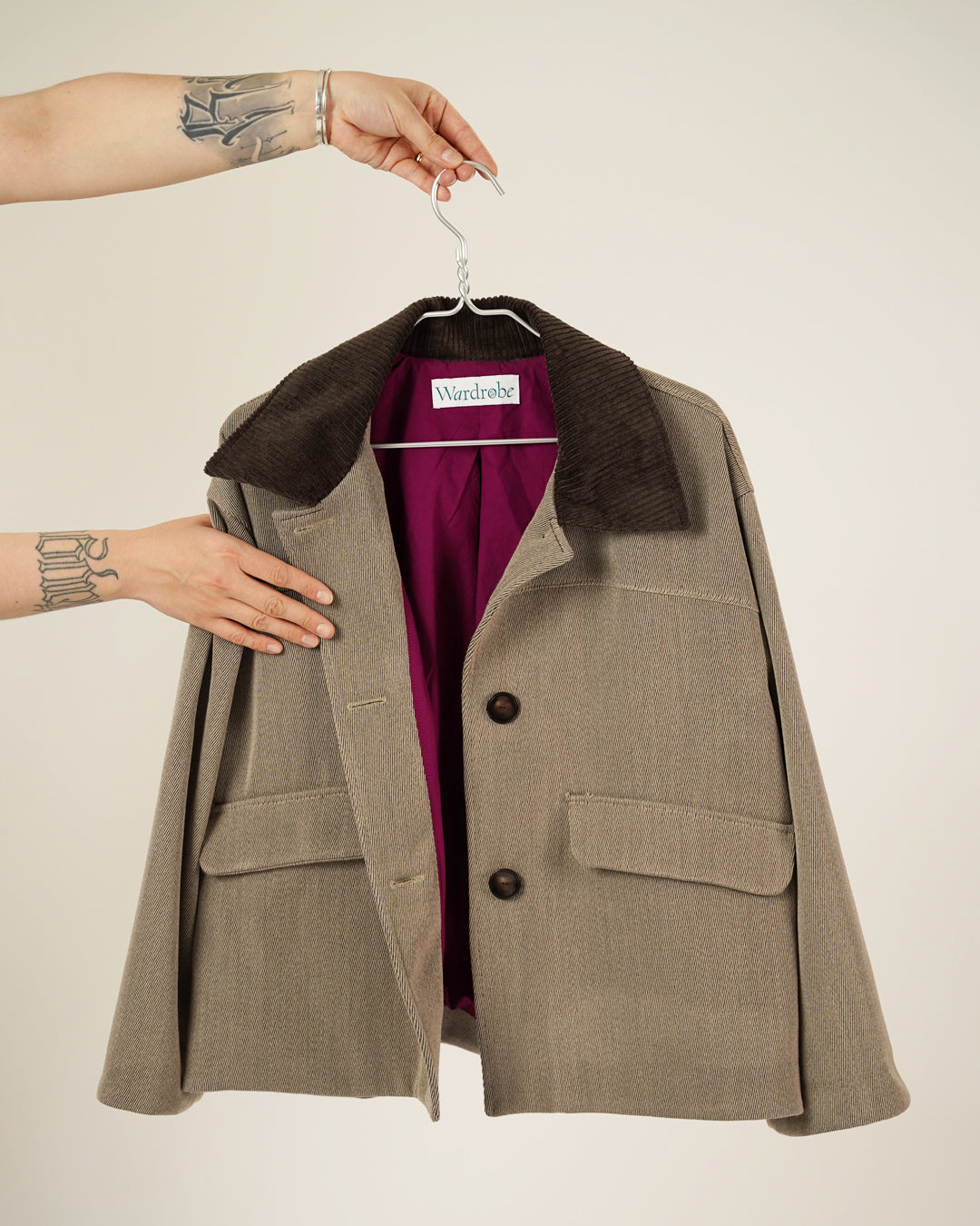 Brown coat with a hanger on a beige background