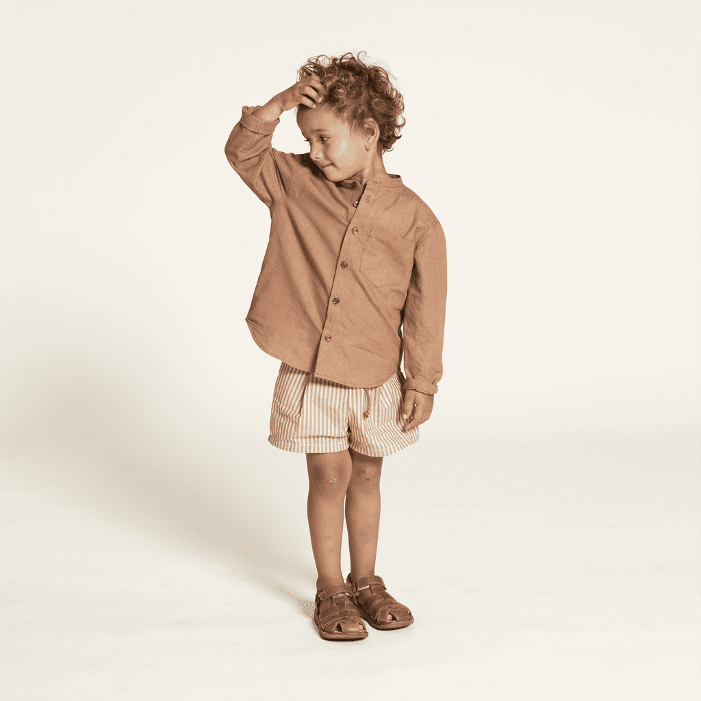 Mini Jensen Shirt Sewing Pattern modeled by a child, featuring a relaxed fit and stylish design suitable for kids ages 3-12.