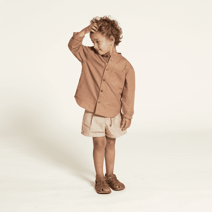 Mini Jensen Shirt Sewing Pattern modeled by a child, featuring a relaxed fit and stylish design suitable for kids ages 3-12.