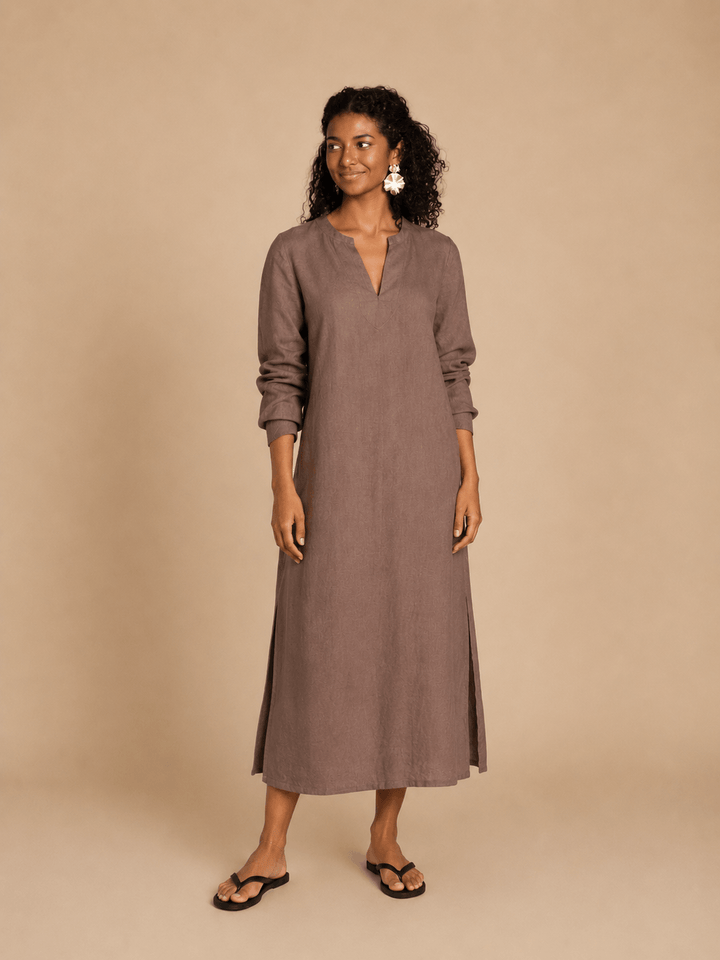 A model wearing a brown Piper Tunic Sewing Pattern, featuring long sleeves and a simple neckline.