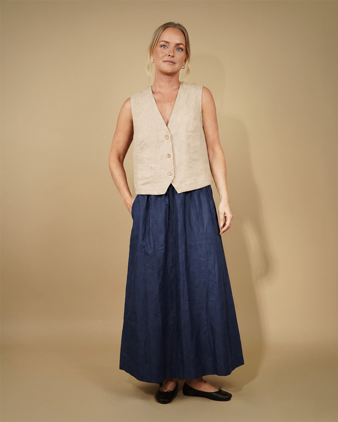 Model wearing a Waistcoat top sewing pattern, a stylish vest layered over a long skirt.