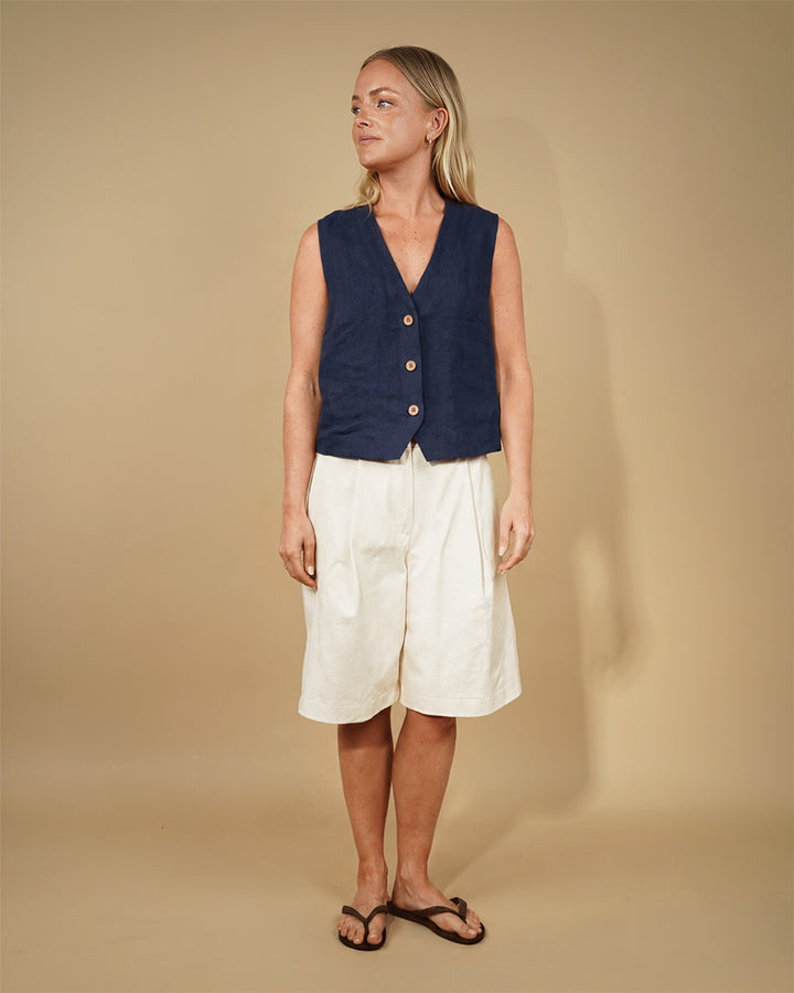 Model showcasing the Waistcoat top sewing pattern with a deep V-neck and three-button closure.