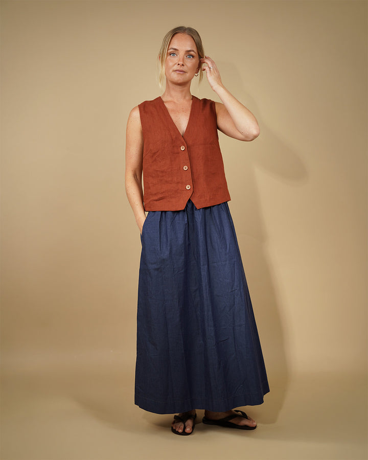 Model wearing a Waistcoat top sewing pattern with a deep V-neckline and three-button front, paired with a maxi skirt.