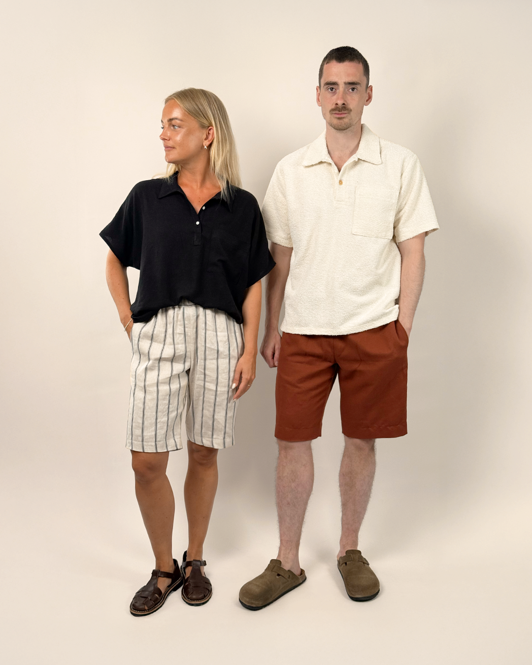 Two people standing side by side against a plain background