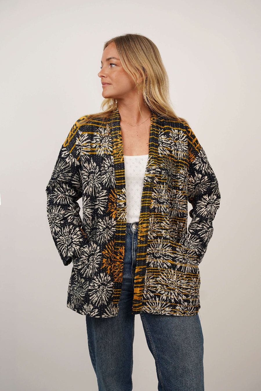 Woman wearing a patterned cardigan on a plain background