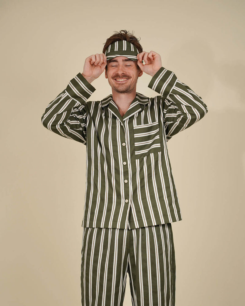 Unisex Pajama set sewing pattern worn by smiling man in striped PJs and matching headband, perfect for comfort and style.