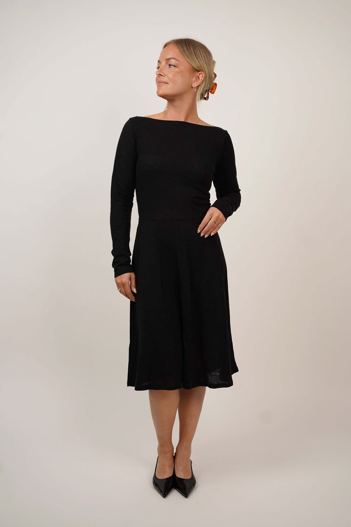 Woman wearing the Asta Dress sewing pattern with long sleeves, front view