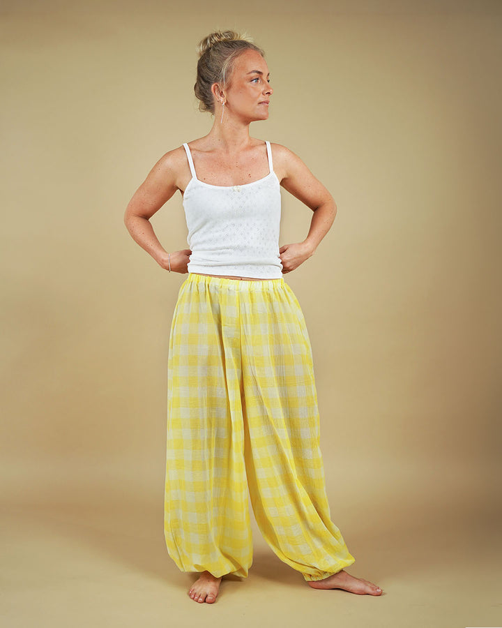 Woman wearing the Carma Camisole and Bubble Pants sewing pattern in yellow checked fabric, front view