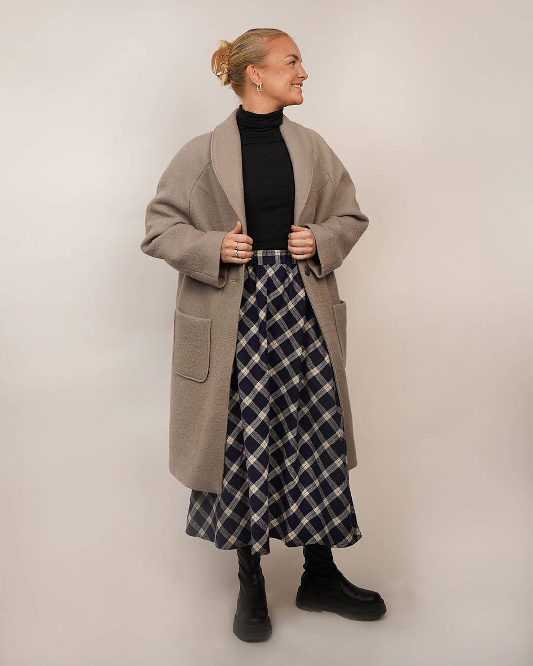 Woman wearing the Cocoon Coat sewing pattern layered over the Claude Skirt sewing pattern, shown from the front