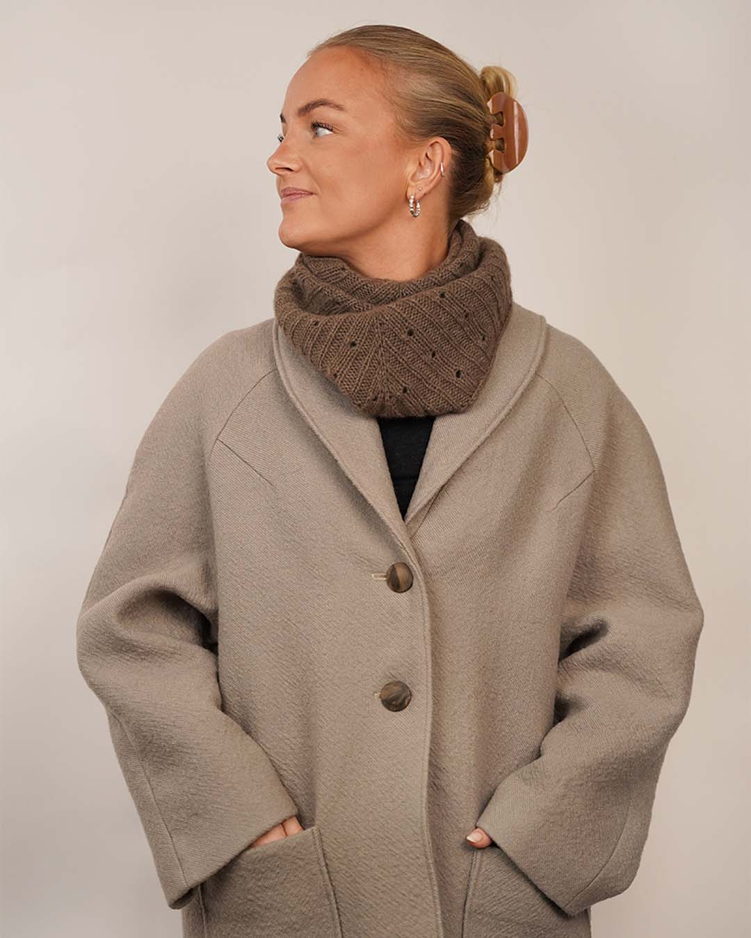 Woman wearing the Cocoon Coat sewing pattern styled with the Onling Scarf, shown from the front