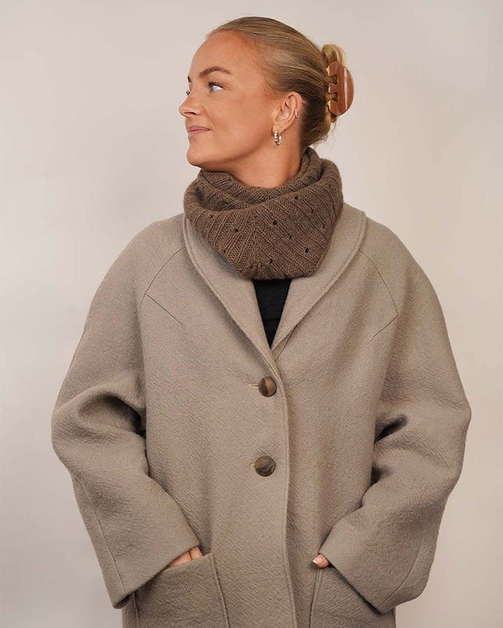 Woman wearing the Cocoon Coat sewing pattern styled with the Onling Scarf, shown from the front
