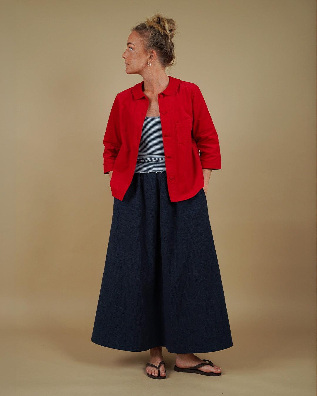 Woman wearing the Dukke Blouse over the Camisole Top and Claude Skirt sewing pattern, front three-quarter view