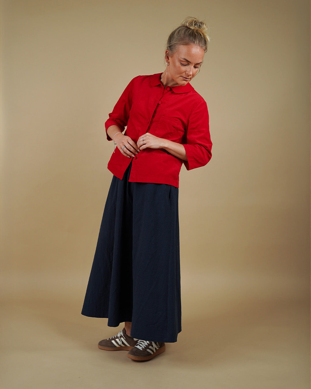 Woman wearing the Dukke Blouse and Claude Skirt sewing pattern, front view
