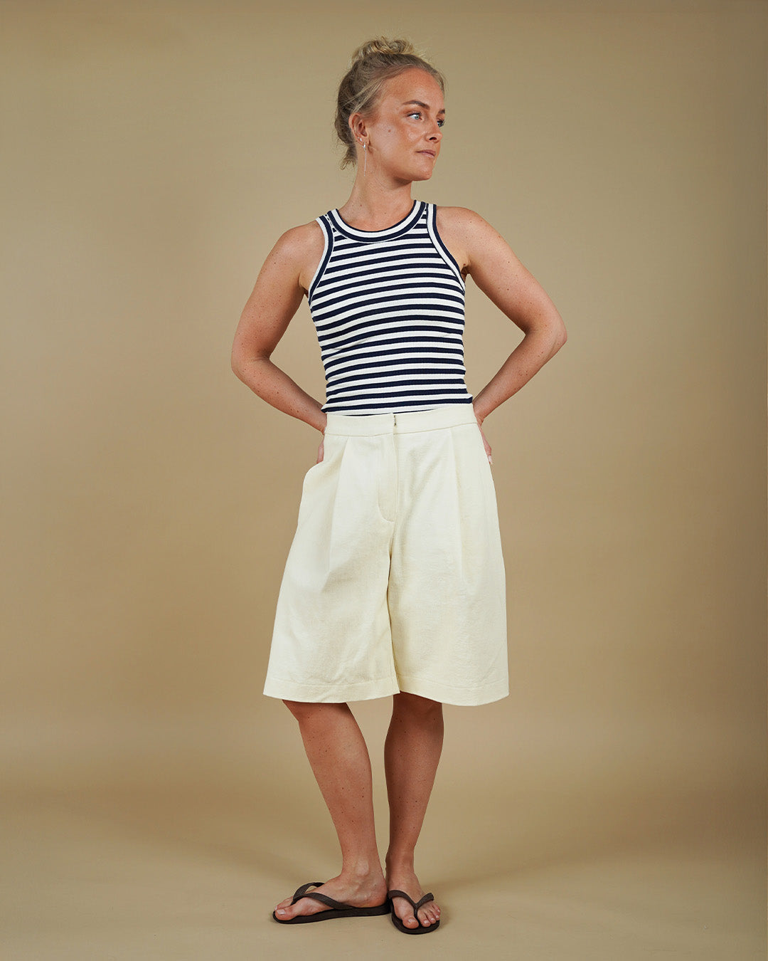 Woman wearing the Muscle Tank and Bermuda Shorts sewing pattern, front three-quarter view