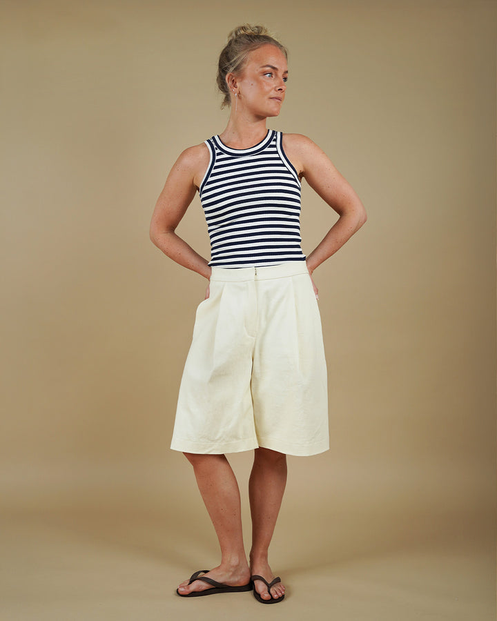 Woman wearing the Muscle Tank and Bermuda Shorts sewing pattern, front three-quarter view