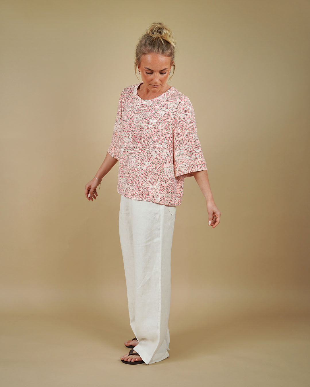 Woman wearing the Silke Blouse and High Waist Pants sewing pattern, side view