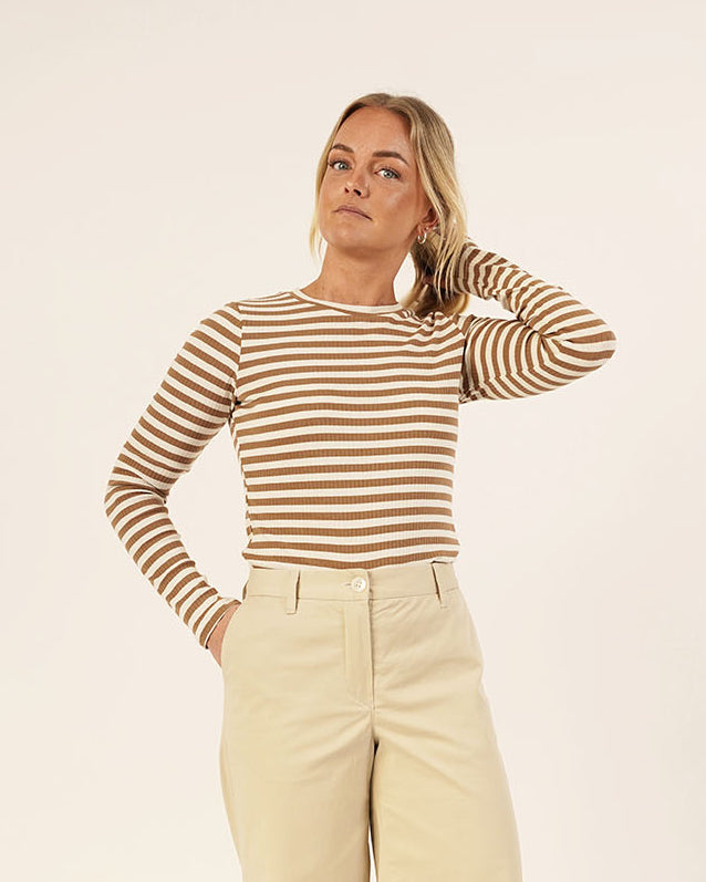 Woman wearing the Wardrobe Builder T-shirt sewing pattern in brown and cream striped knit paired with Hepburn Pants in beige cotton twill