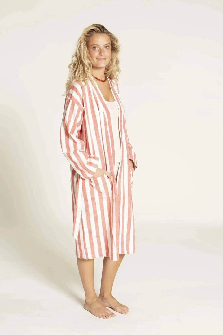 Woman wearing a red and white striped Norma Jean Kimono robe on a plain background