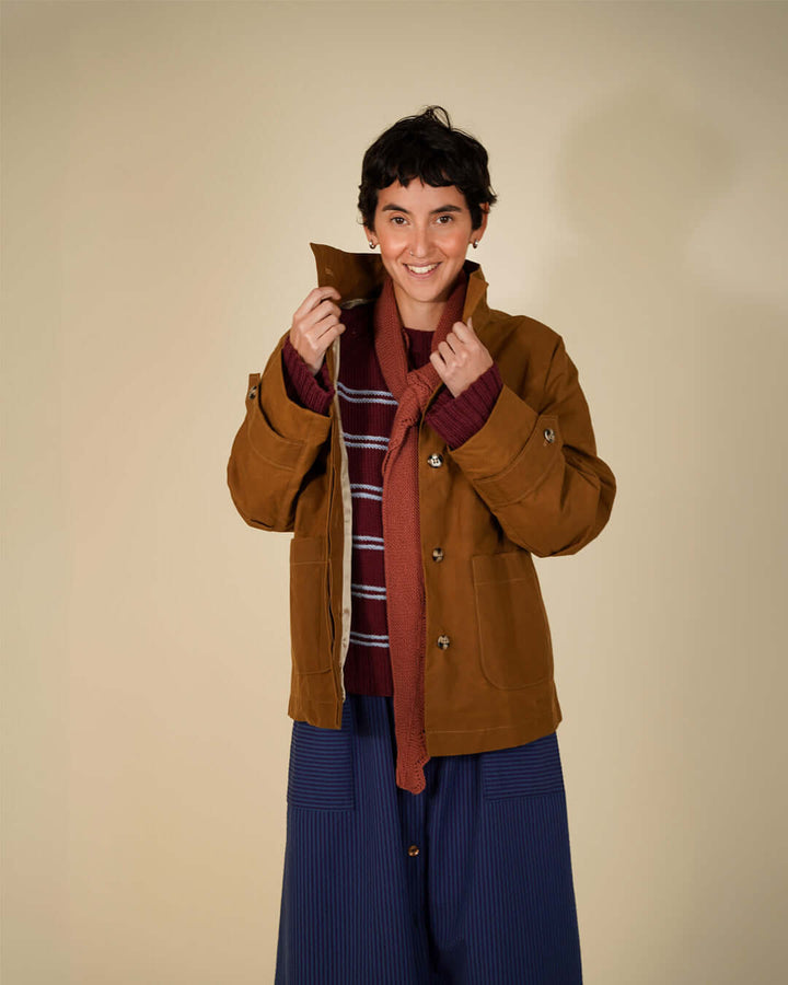 Model wearing Wardrobe By Me Funnel Neck Jacket sewing pattern in brown, styled with a layered outfit and a relaxed silhouette.